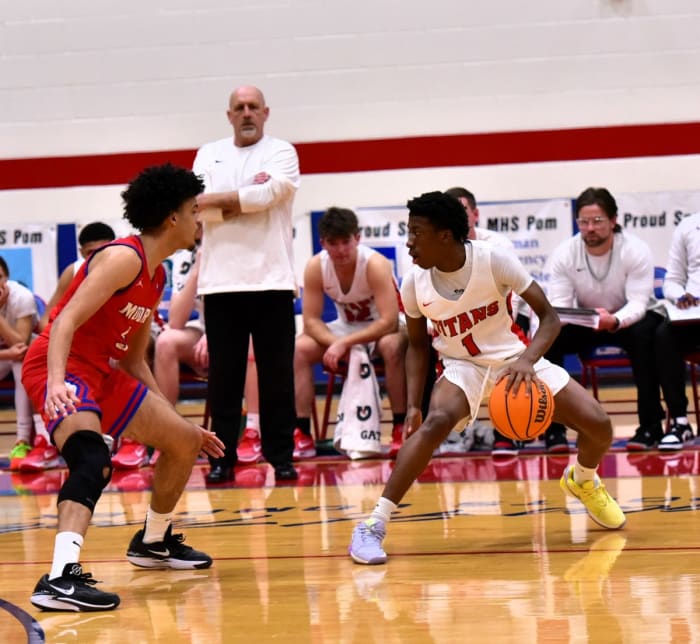 Action between Moore (in red) and Midwest City Carl Albert in the championship game of the John Nobles Invitational on Jan. 20, 2024. The Lions defeated the Titans.